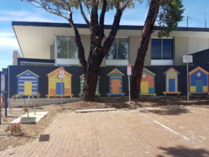 fence painted with colourful beach huts